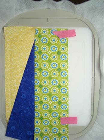 RNK Embroidery Perfection Tape holding back folded fabric in the hoop